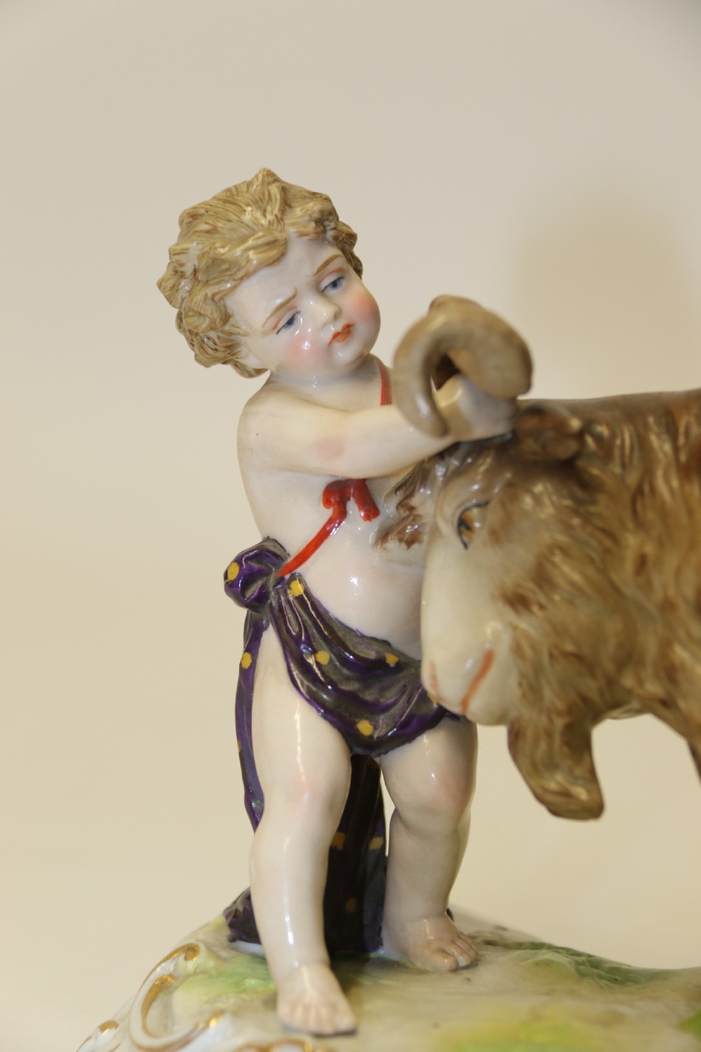 A fine Porcelain Figure Group of three Putti Wrestling with a Goat by Hochst Factory View IX
