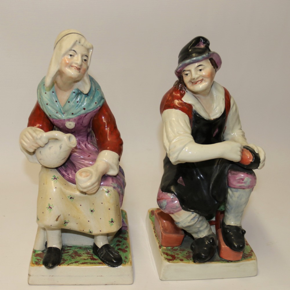 A large pair of  19th C Staffordshire Pottery Seated figures.