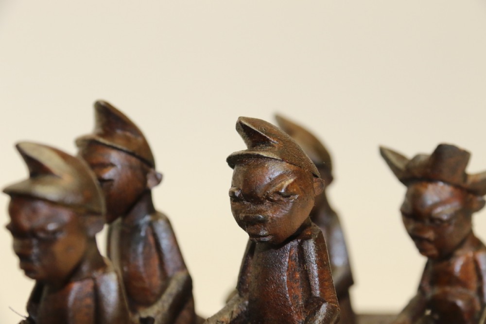 An African Carved Wooden model of a dug-out canoe with 18 seated tribal figures. View VII