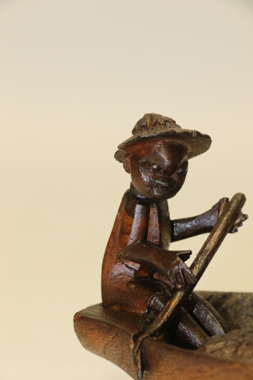 An African Carved Wooden model of a dug-out canoe with 18 seated tribal figures. View VIII