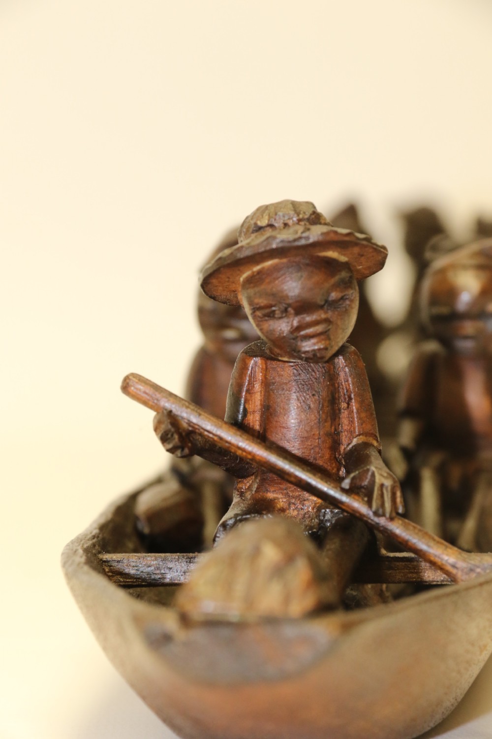 An African Carved Wooden model of a dug-out canoe with 18 seated tribal figures. View X