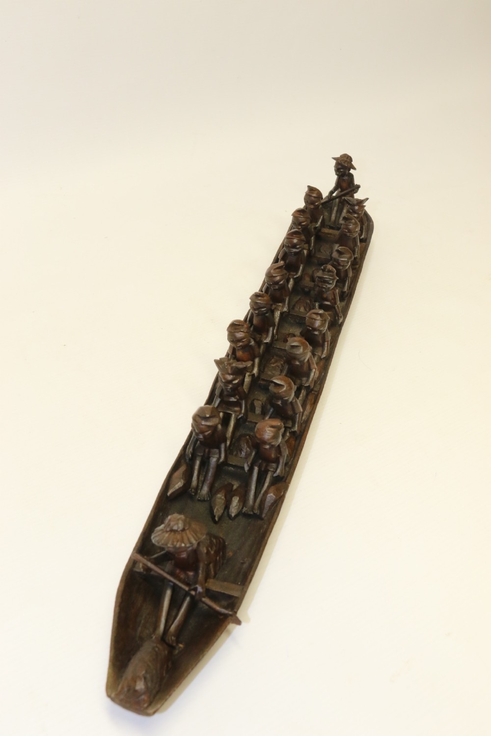 An African Carved Wooden model of a dug-out canoe with 18 seated tribal figures. View XII