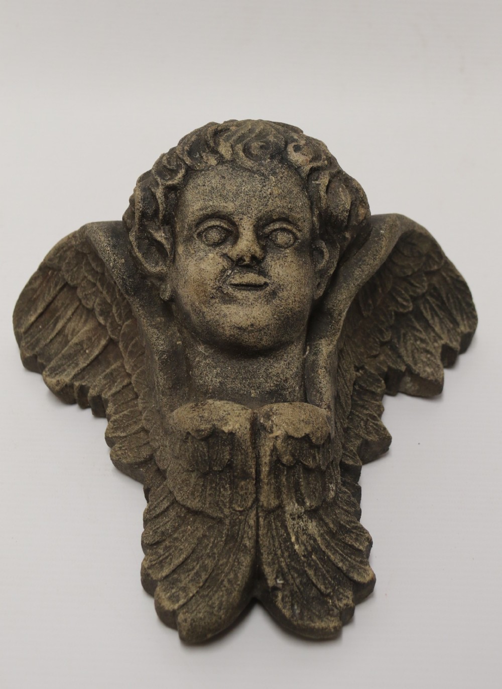 A hand carved Portland Stone Wall Cherub, signed M. R Bland,1874