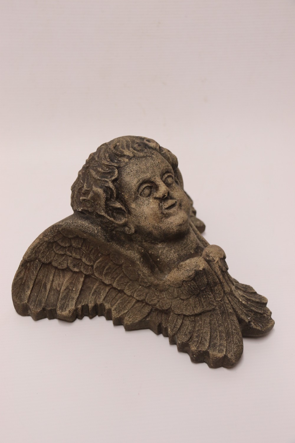 A hand carved Portland Stone Wall Cherub, signed M. R Bland,1874 View II