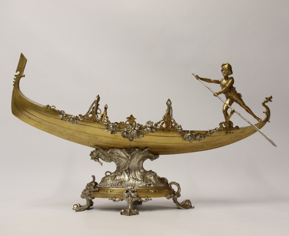 A fine silver and gilt bronze table centre piece in the form of a gondola 