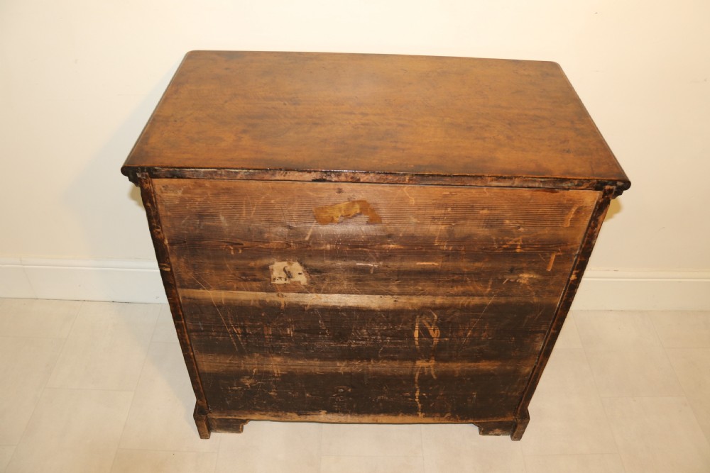 An 18th-century English walnut bachelors writing chest featuring four graduated drawers, brass plate handles, bracket feet, and side carrying handles. View II
