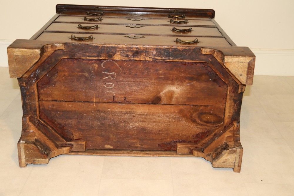 An 18th-century English walnut bachelors writing chest featuring four graduated drawers, brass plate handles, bracket feet, and side carrying handles. View III