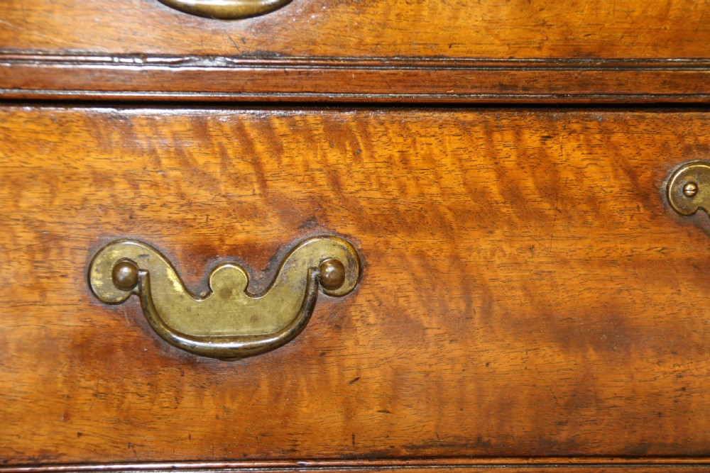 An 18th-century English walnut bachelors writing chest featuring four graduated drawers, brass plate handles, bracket feet, and side carrying handles. View XI