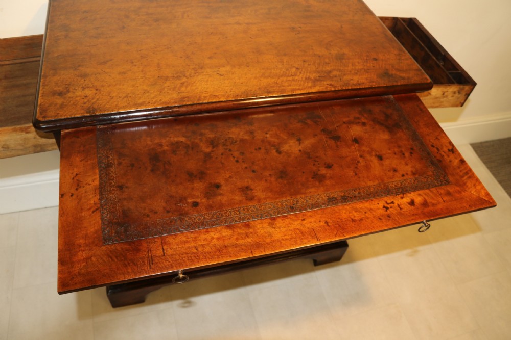 An 18th-century English walnut bachelors writing chest featuring four graduated drawers, brass plate handles, bracket feet, and side carrying handles. View XIV