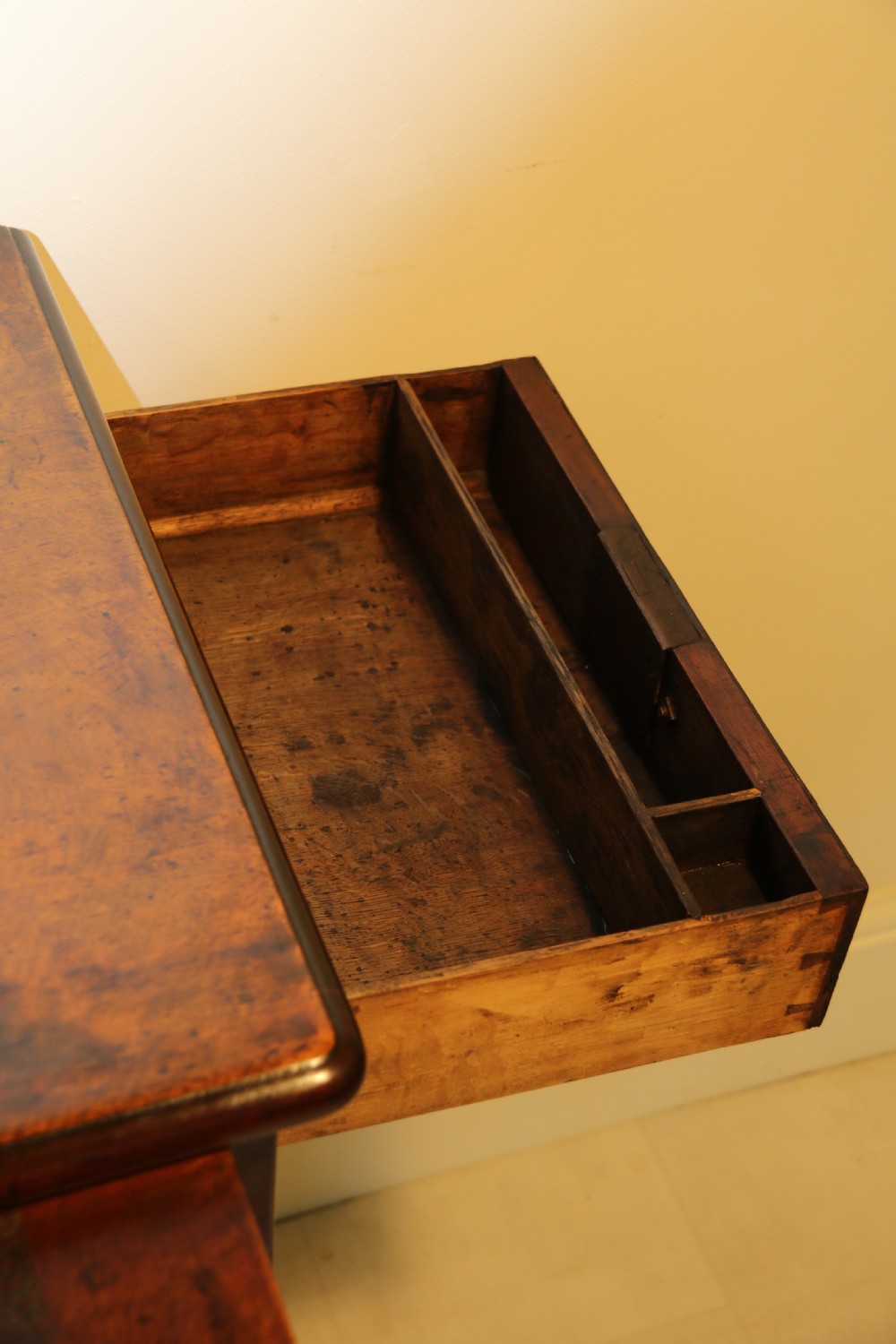 An 18th-century English walnut bachelors writing chest featuring four graduated drawers, brass plate handles, bracket feet, and side carrying handles. View XVI