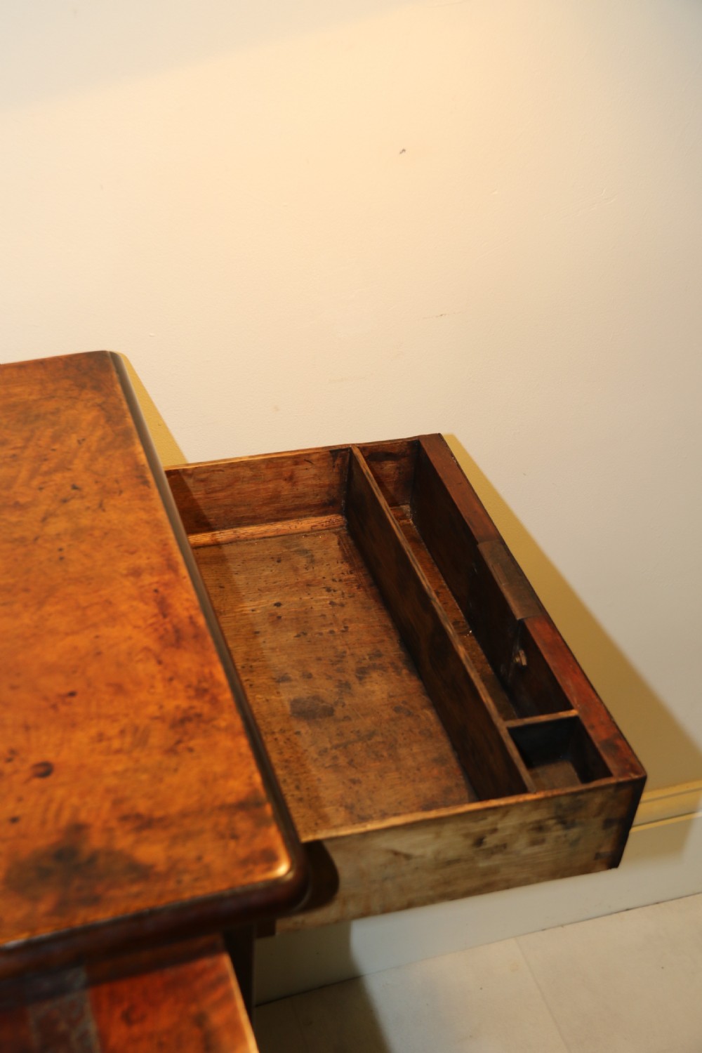 An 18th-century English walnut bachelors writing chest featuring four graduated drawers, brass plate handles, bracket feet, and side carrying handles. View XVII