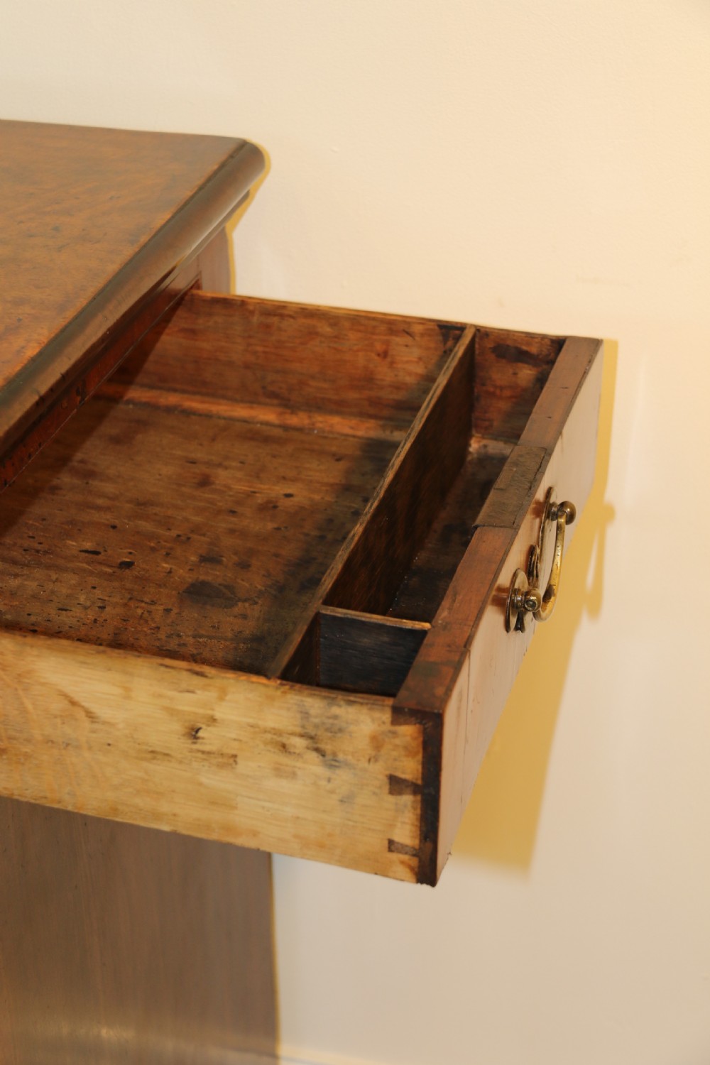 An 18th-century English walnut bachelors writing chest featuring four graduated drawers, brass plate handles, bracket feet, and side carrying handles. View XIX