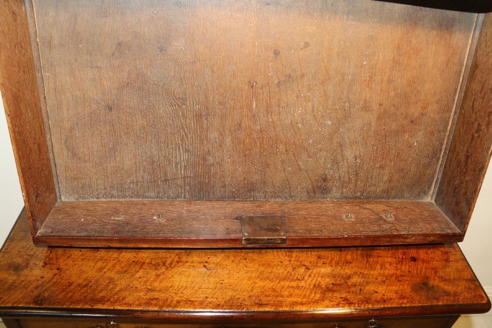 An 18th-century English walnut bachelors writing chest featuring four graduated drawers, brass plate handles, bracket feet, and side carrying handles. View XXI