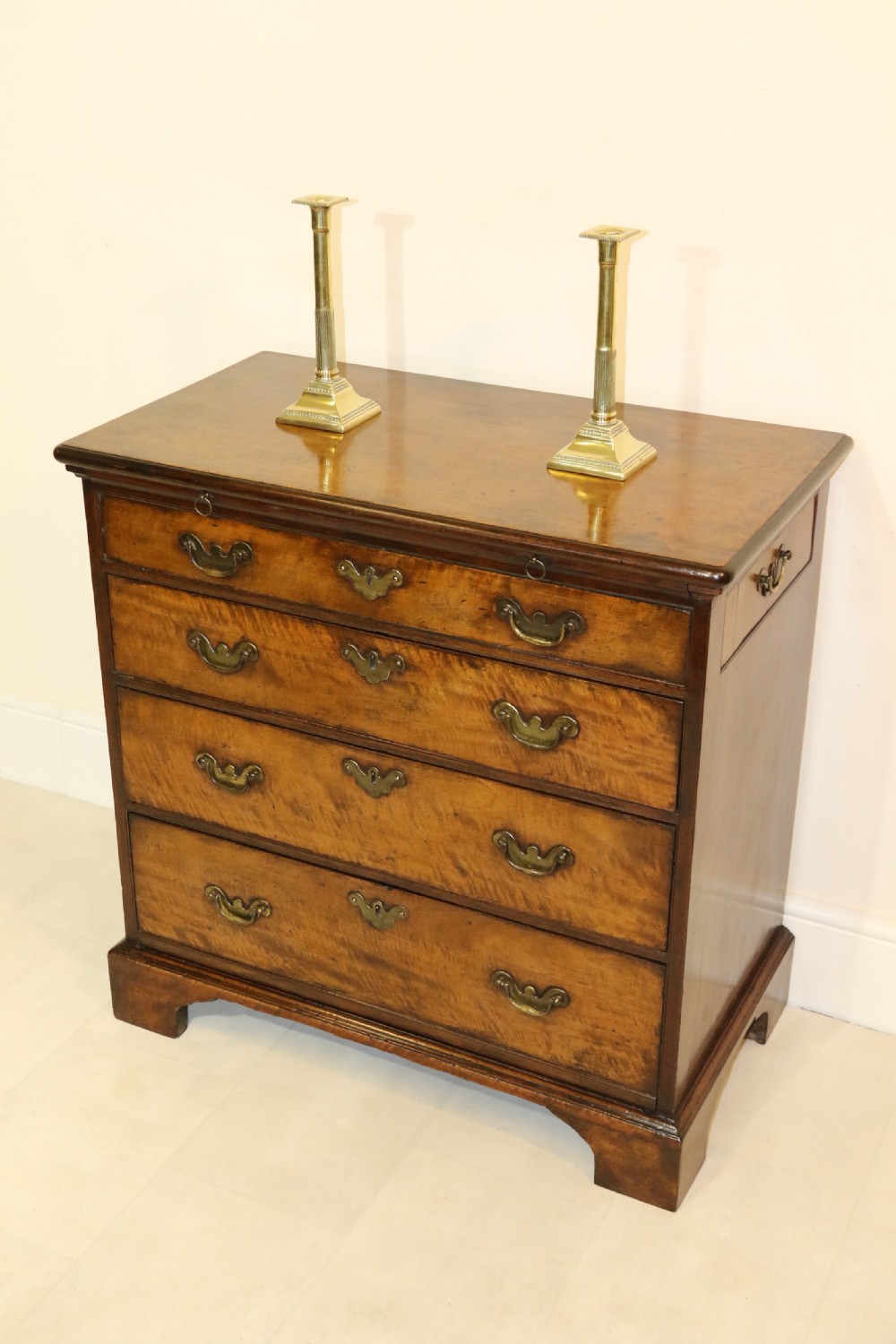 An 18th-century English walnut bachelors writing chest featuring four graduated drawers, brass plate handles, bracket feet, and side carrying handles. View XXVII