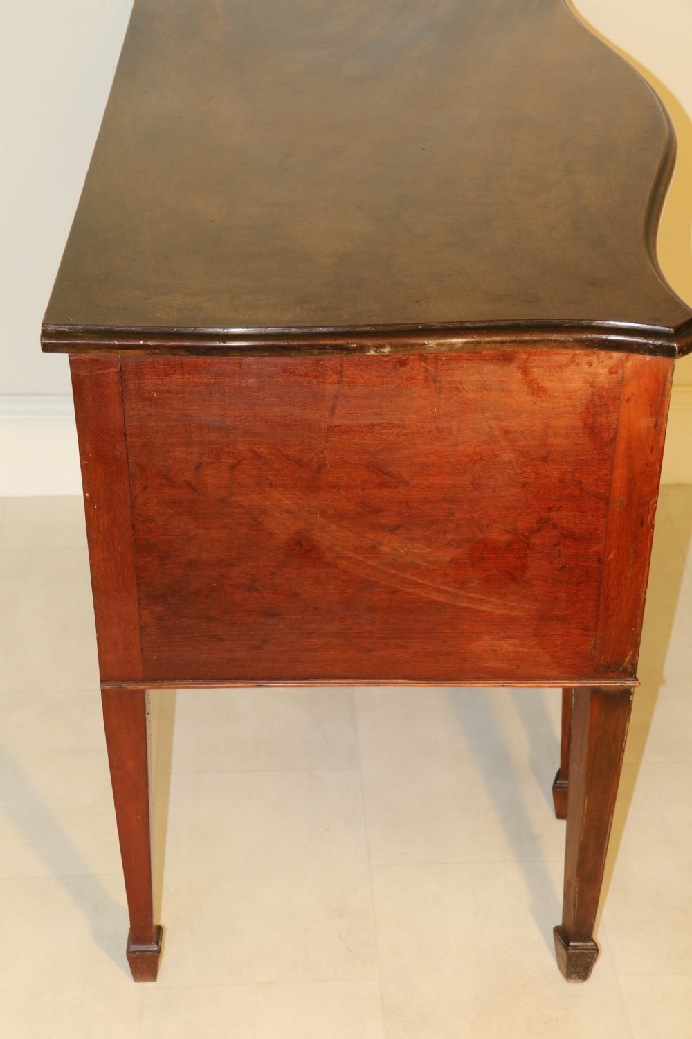 A Georgian serpentine fronted side table with writing and dressing fitment View III