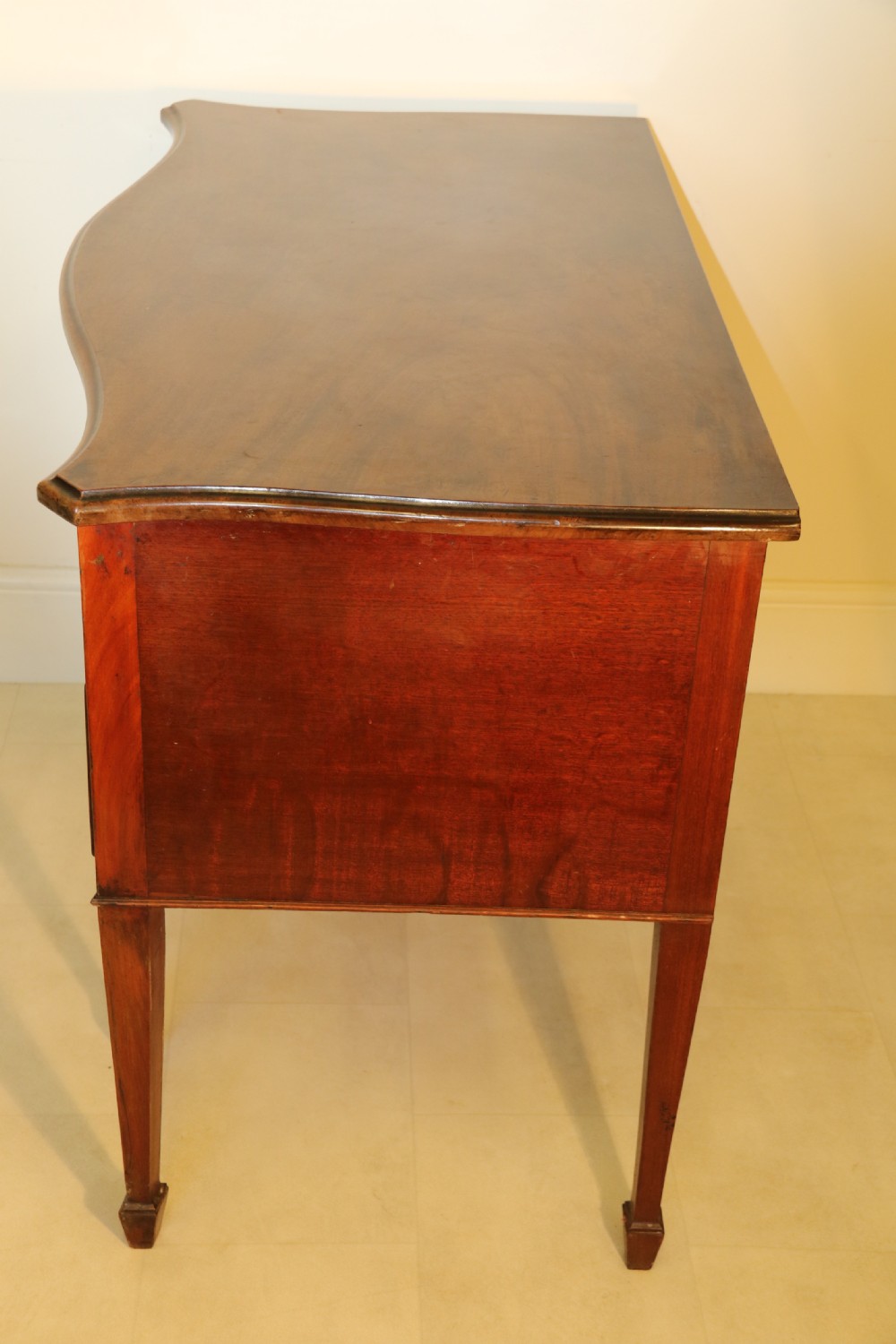 A Georgian serpentine fronted side table with writing and dressing fitment View IV