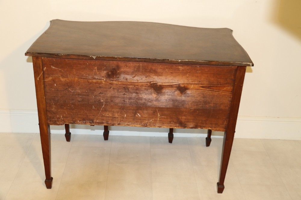 A Georgian serpentine fronted side table with writing and dressing fitment View V