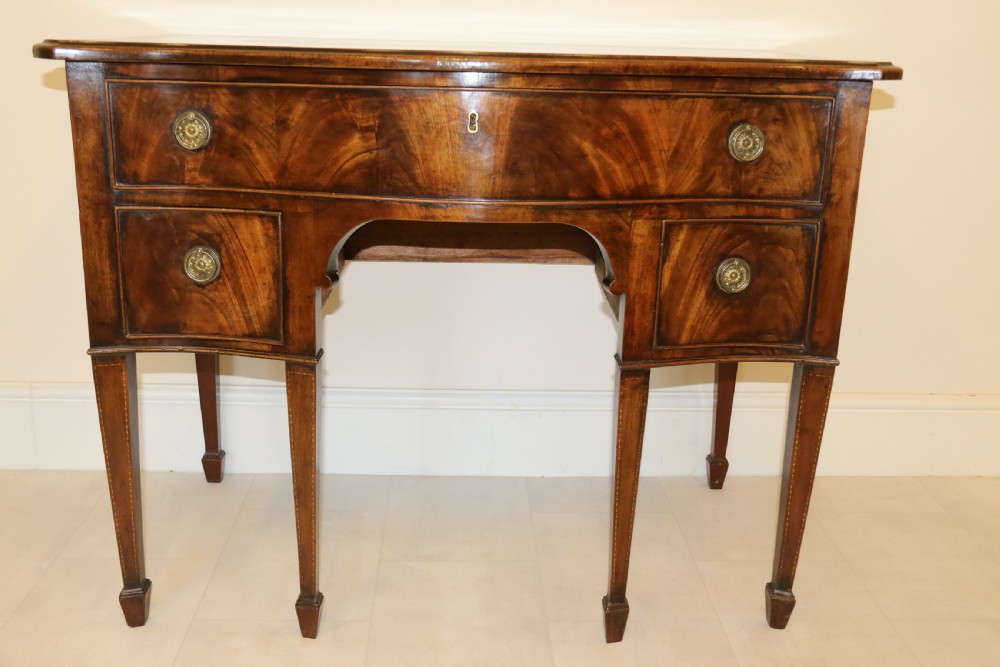A Georgian serpentine fronted side table with writing and dressing fitment View XI