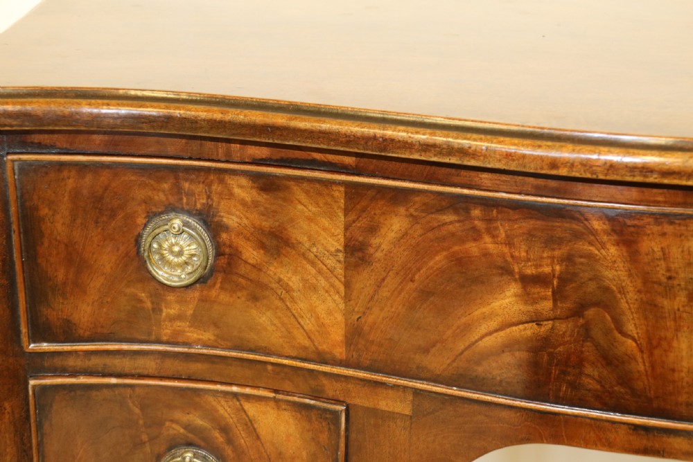 A Georgian serpentine fronted side table with writing and dressing fitment View XII