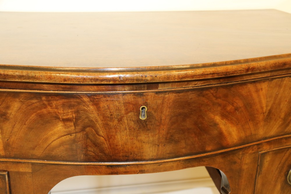 A Georgian serpentine fronted side table with writing and dressing fitment View XIII