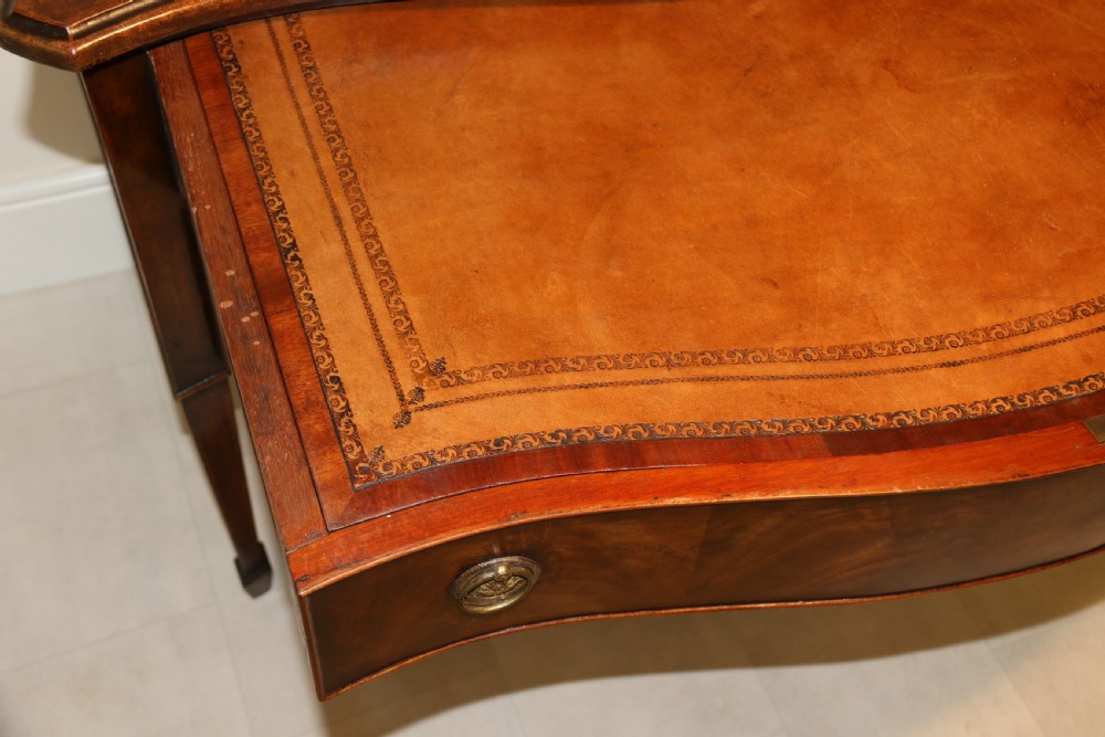 A Georgian serpentine fronted side table with writing and dressing fitment View XXI