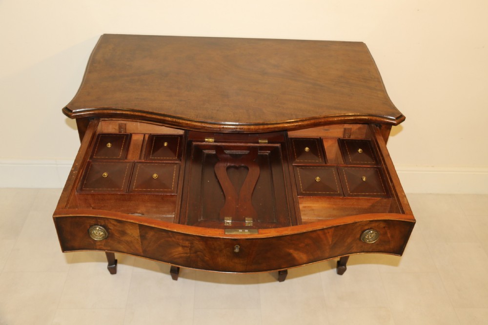A Georgian serpentine fronted side table with writing and dressing fitment View XXII