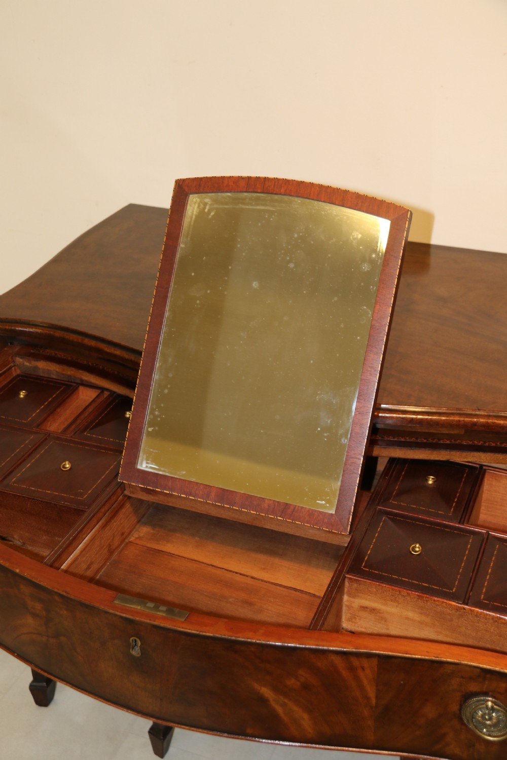 A Georgian serpentine fronted side table with writing and dressing fitment View XXVI