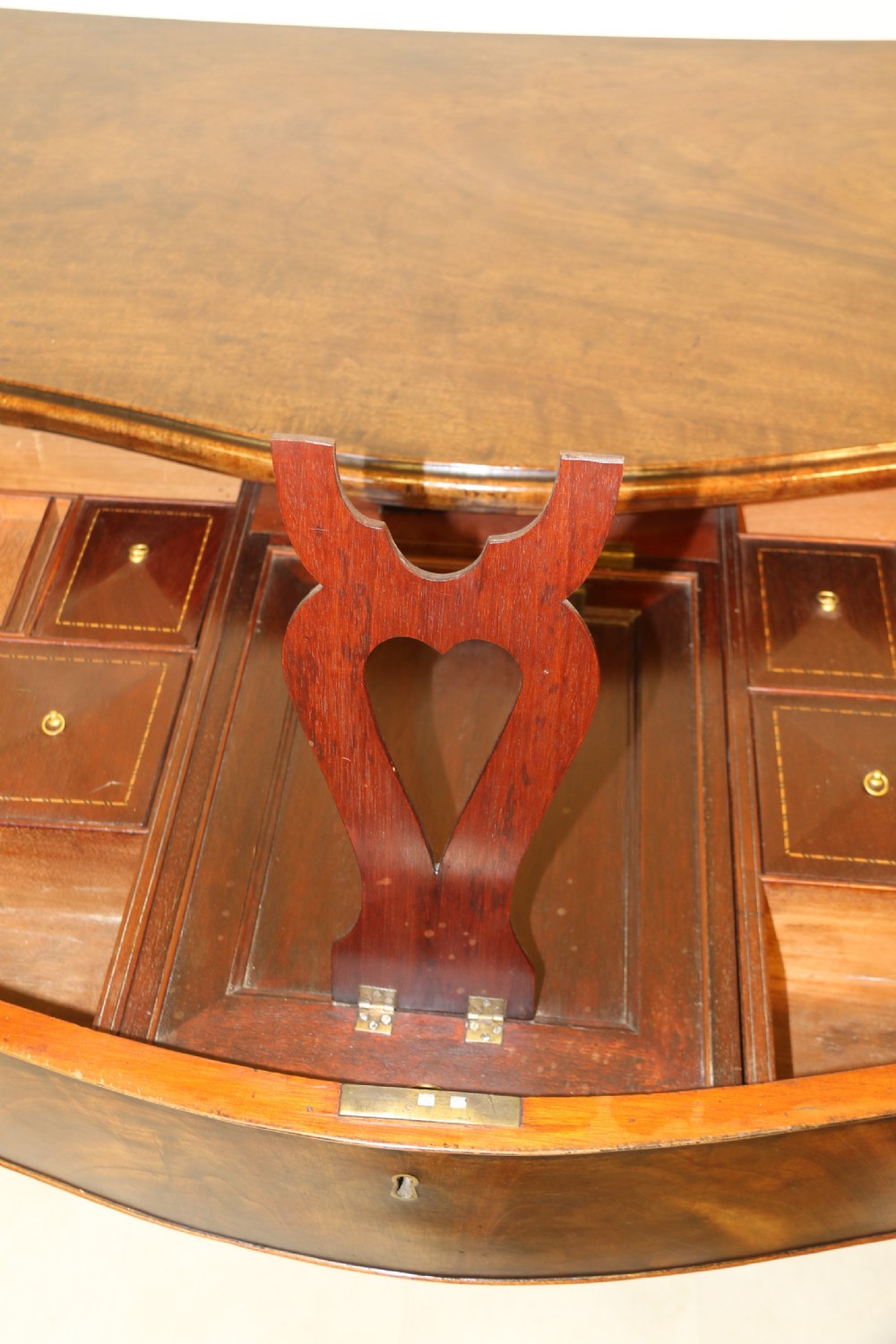 A Georgian serpentine fronted side table with writing and dressing fitment View XXVIII