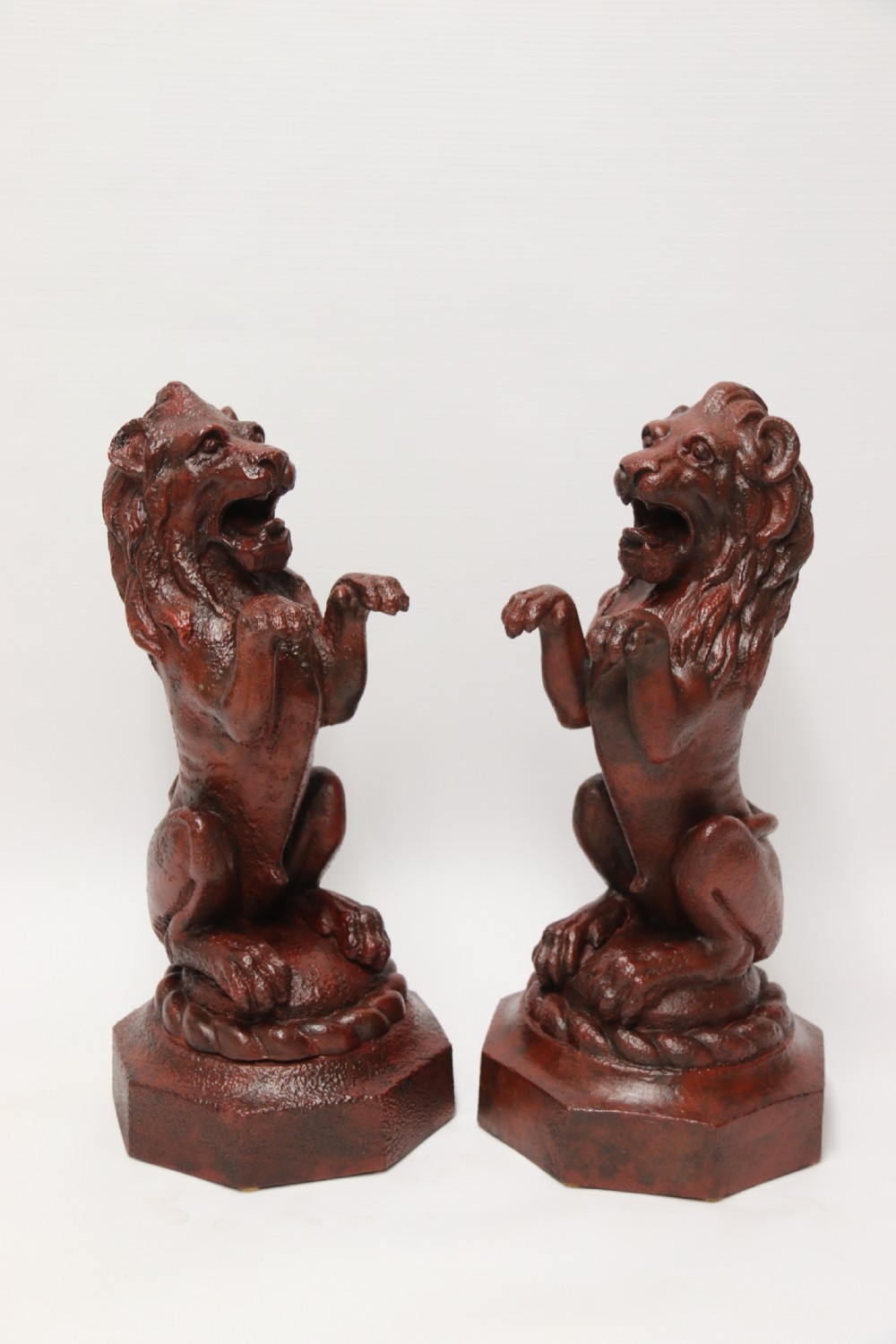 A pair of Regency period cast iron lion doorstops