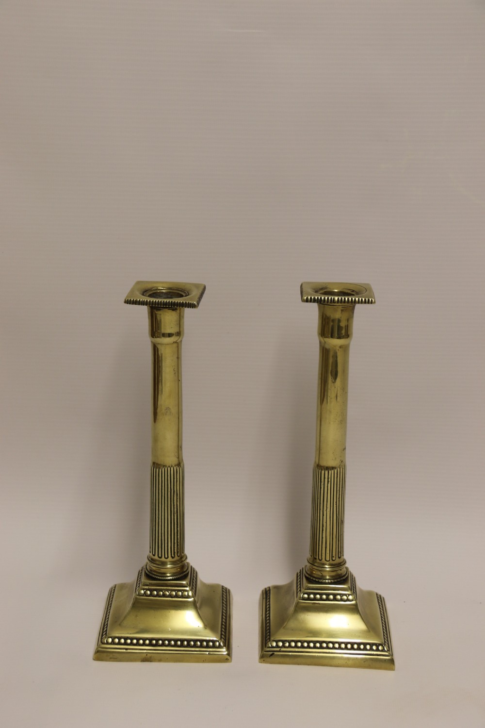 A good pair of English George III brass candlesticks. View II