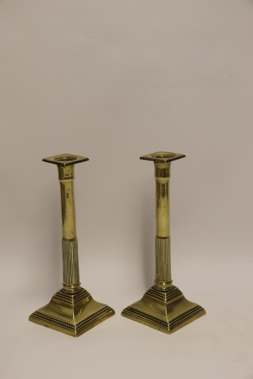 A good pair of English George III brass candlesticks. View III