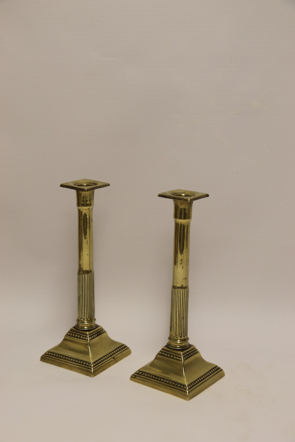 A good pair of English George III brass candlesticks. View IV