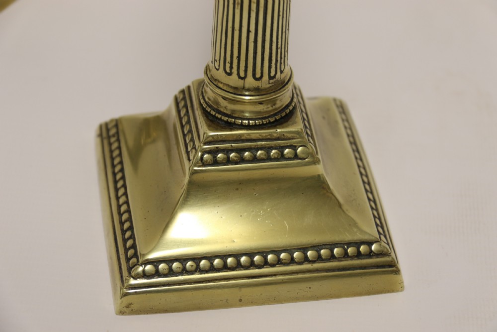A good pair of English George III brass candlesticks. View V