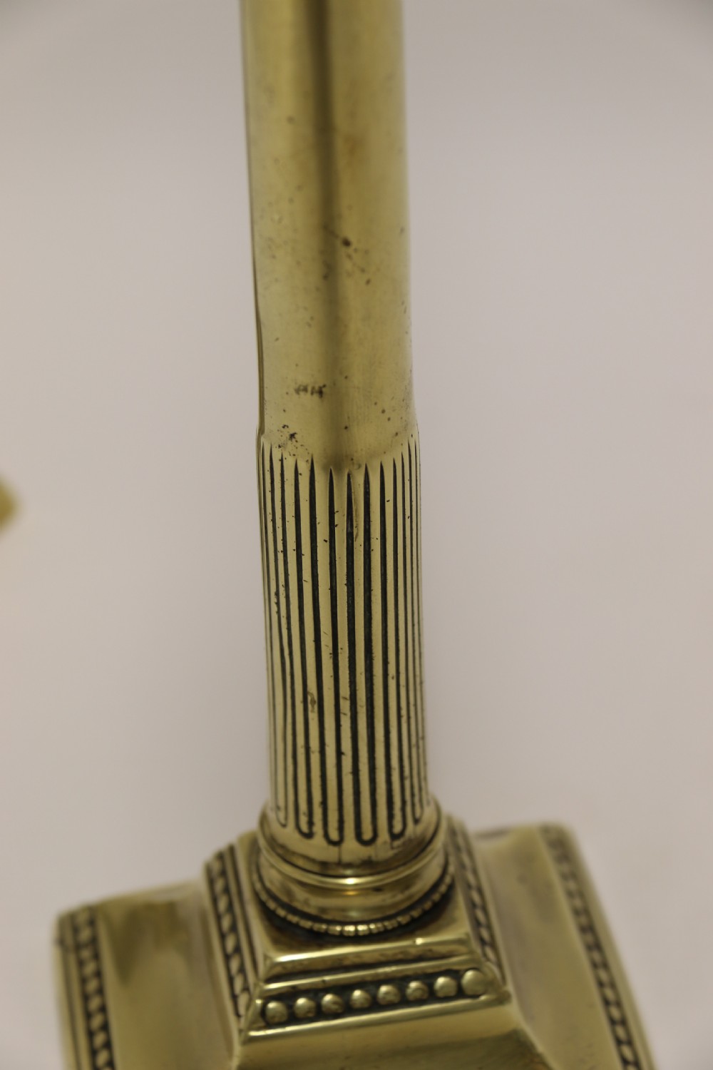 A good pair of English George III brass candlesticks. View VI