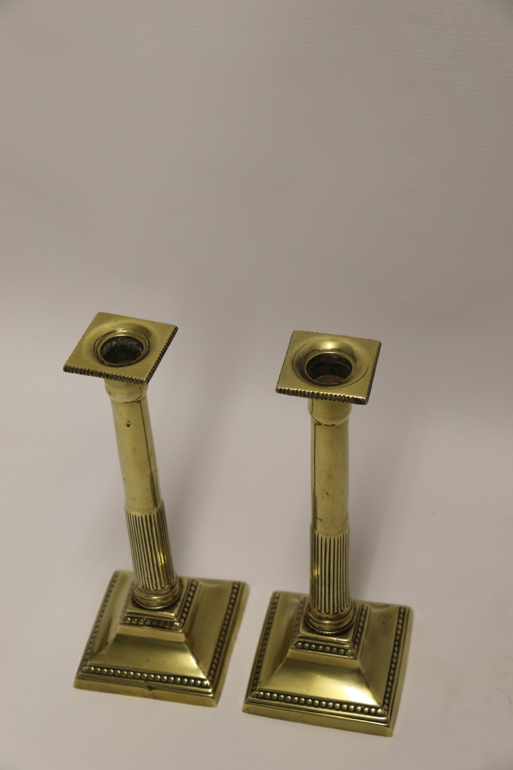 A good pair of English George III brass candlesticks. View X