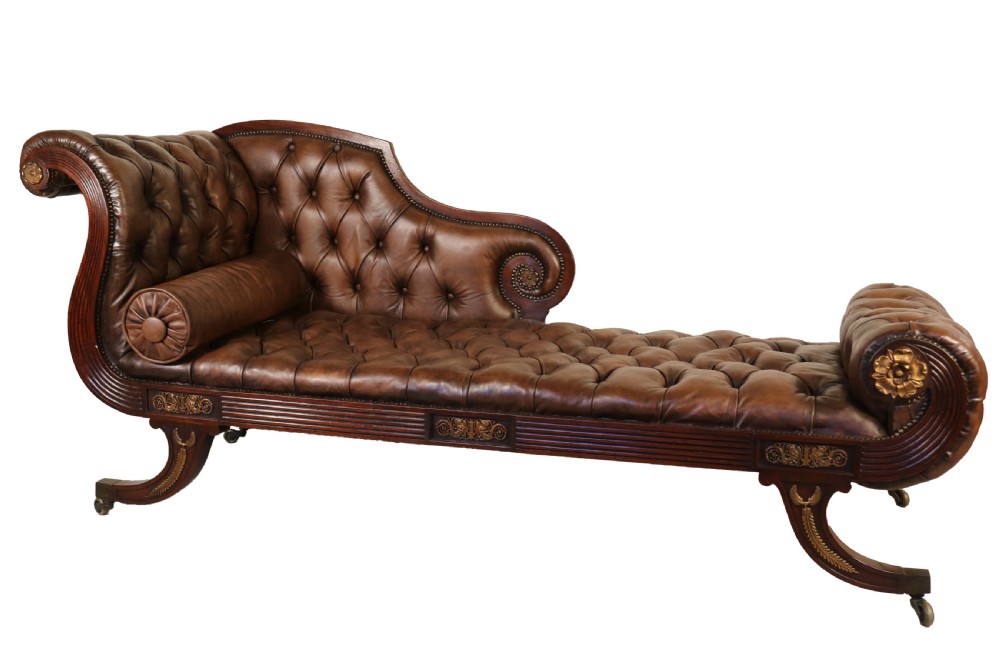 A splendid Regency mahogany and brass mounted deep buttoned leather upholstered chaise lounge