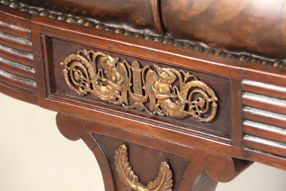 A splendid Regency mahogany and brass mounted deep buttoned leather upholstered chaise lounge View III