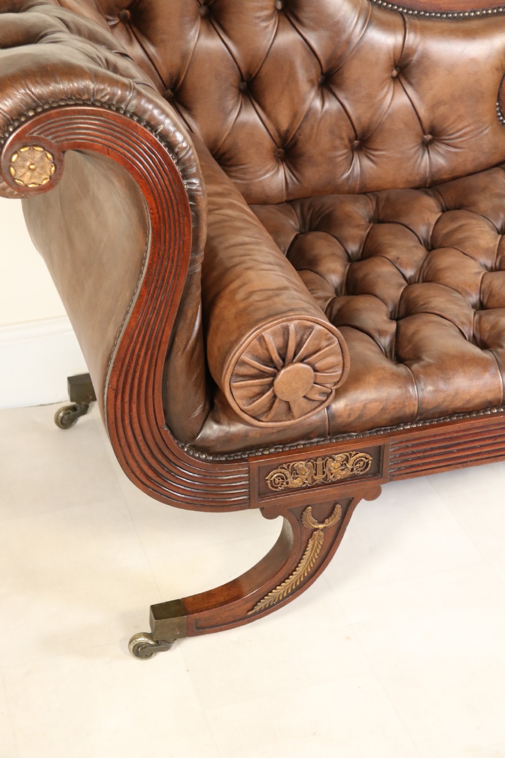 A splendid Regency mahogany and brass mounted deep buttoned leather upholstered chaise lounge View VI