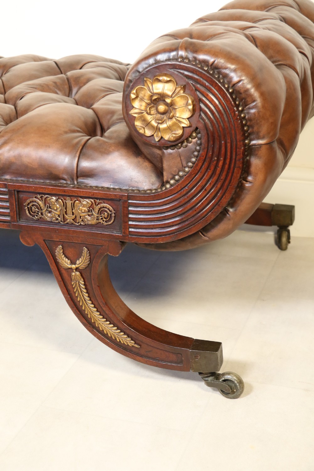 A splendid Regency mahogany and brass mounted deep buttoned leather upholstered chaise lounge View VIII