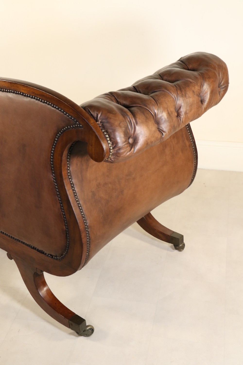 A splendid Regency mahogany and brass mounted deep buttoned leather upholstered chaise lounge View XVII