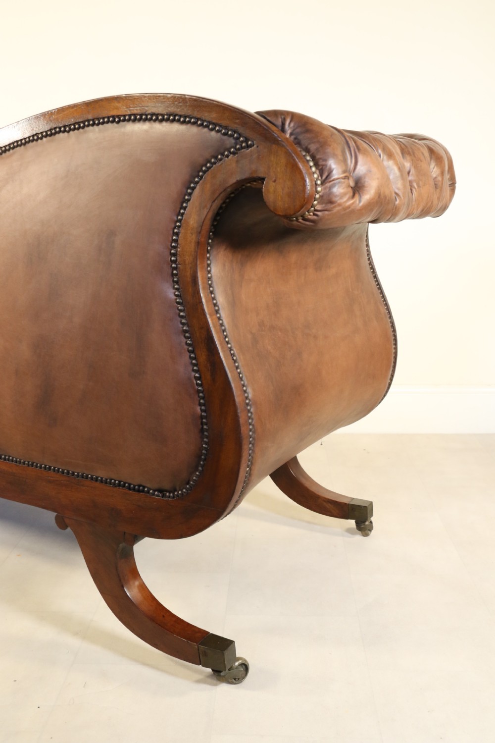 A splendid Regency mahogany and brass mounted deep buttoned leather upholstered chaise lounge View XIX