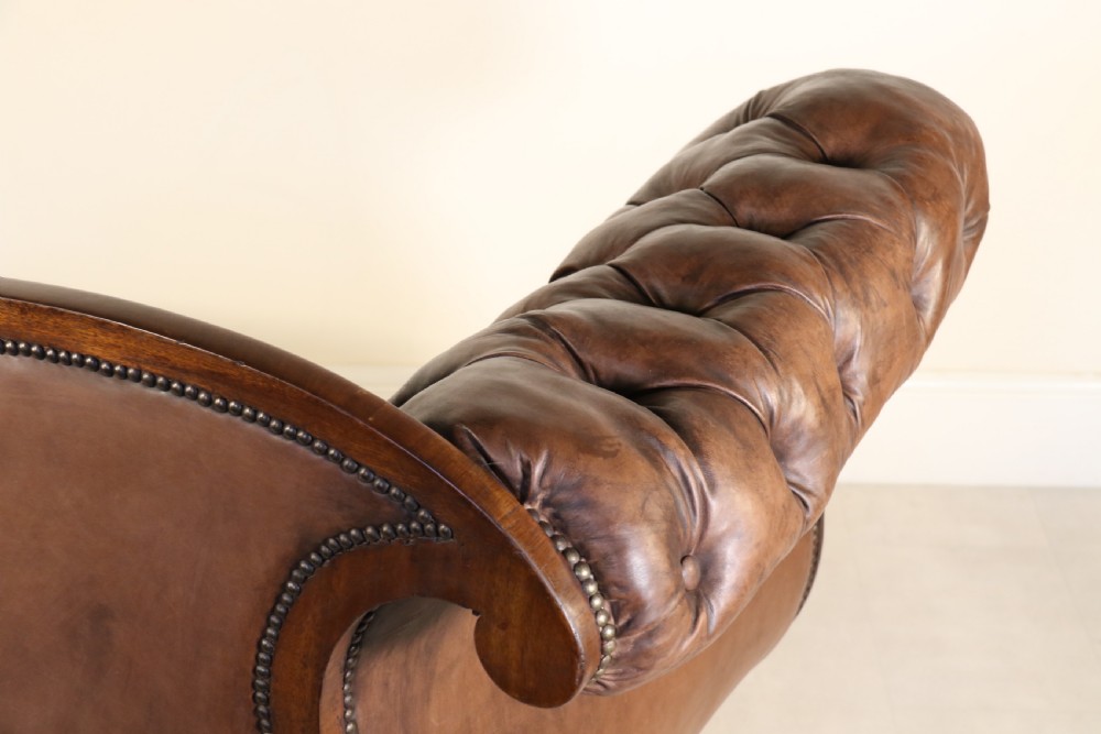 A splendid Regency mahogany and brass mounted deep buttoned leather upholstered chaise lounge View XX