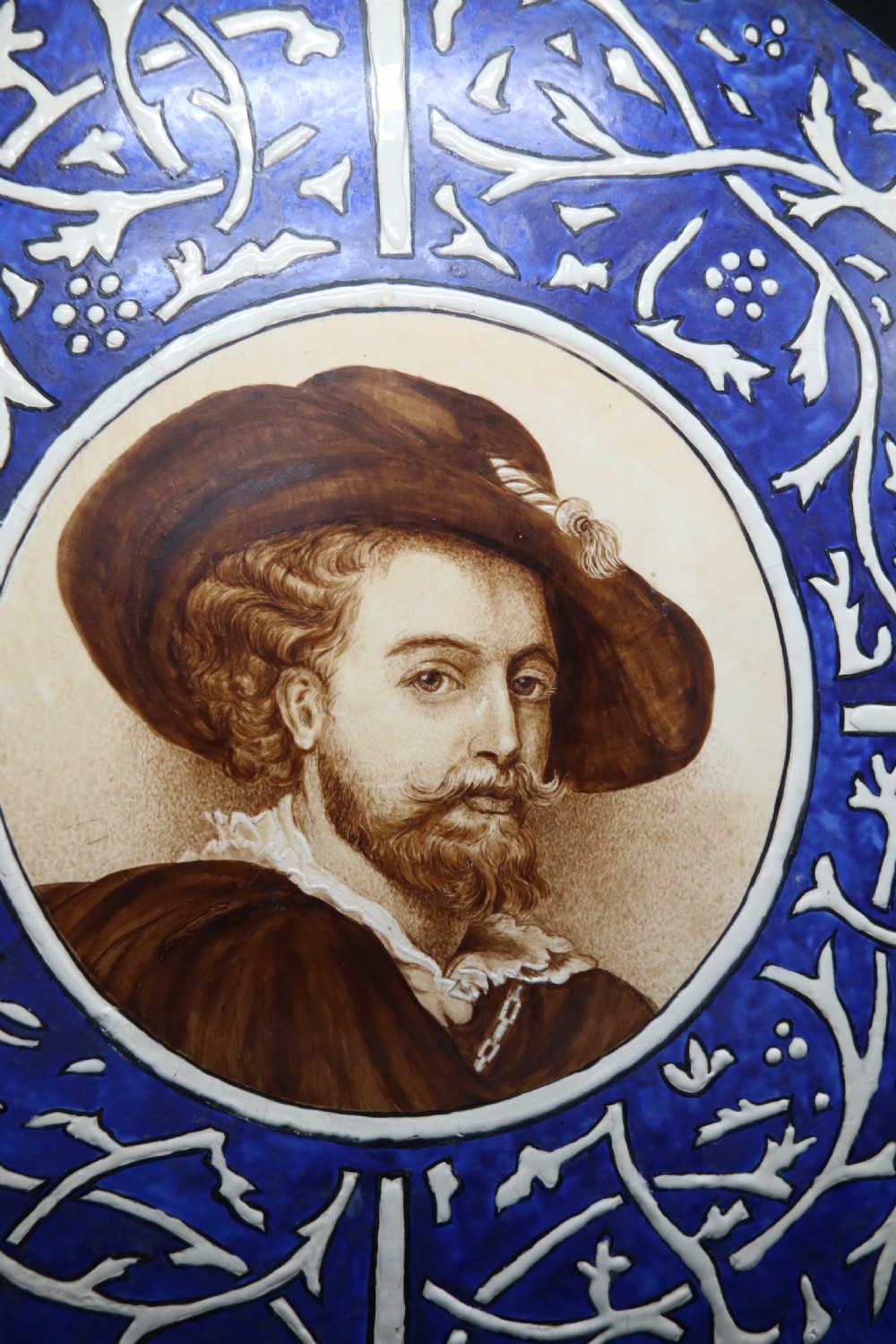 A bold impressive hand painted Continental pottery plaque with a central portrait of Rubens View III
