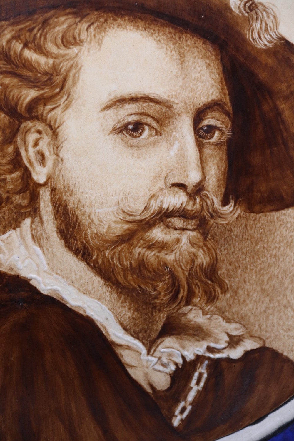 A bold impressive hand painted Continental pottery plaque with a central portrait of Rubens View XVII