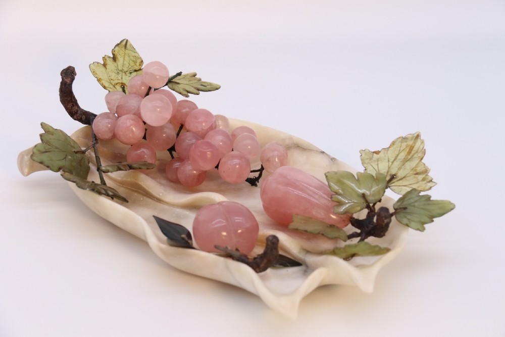 A Chinese hardstone collection of fruit together with a carved alabaster leaf dish View II