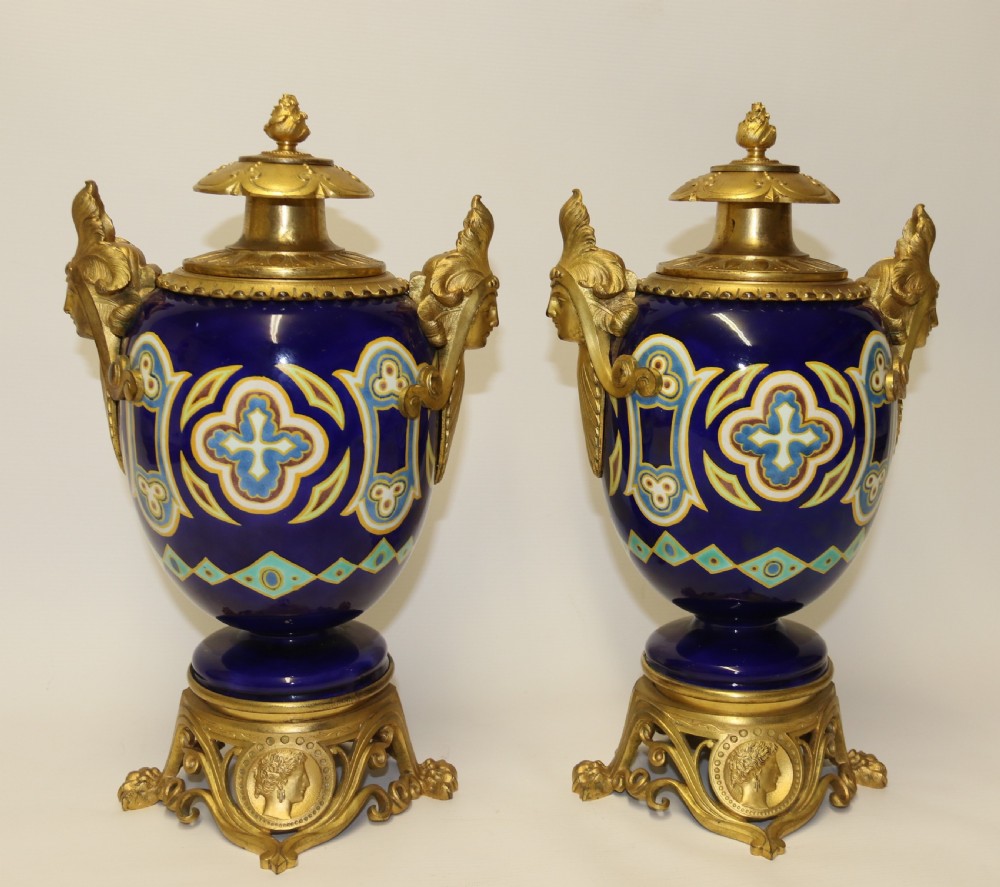 A superb pair of gilt bronze and pottery Aztec design vases/ urns
