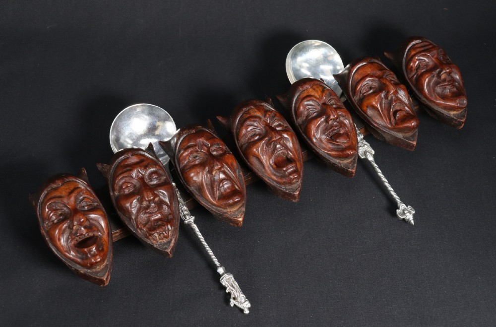 A superb Black Forest spoon rack carved in the devilish faces of the seven deadly sins.