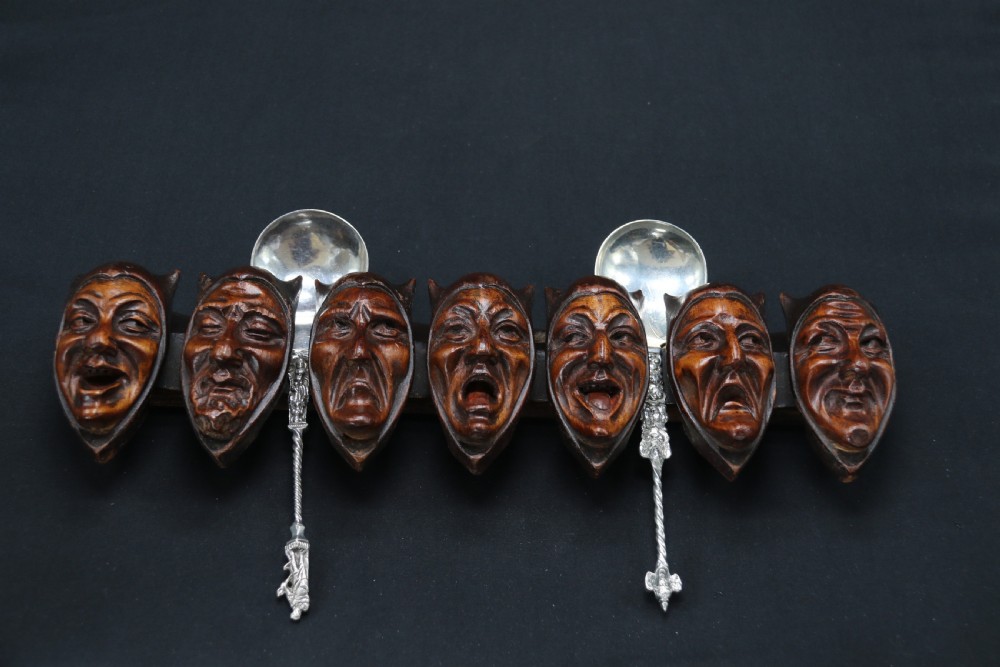 A superb Black Forest spoon rack carved in the devilish faces of the seven deadly sins. View II