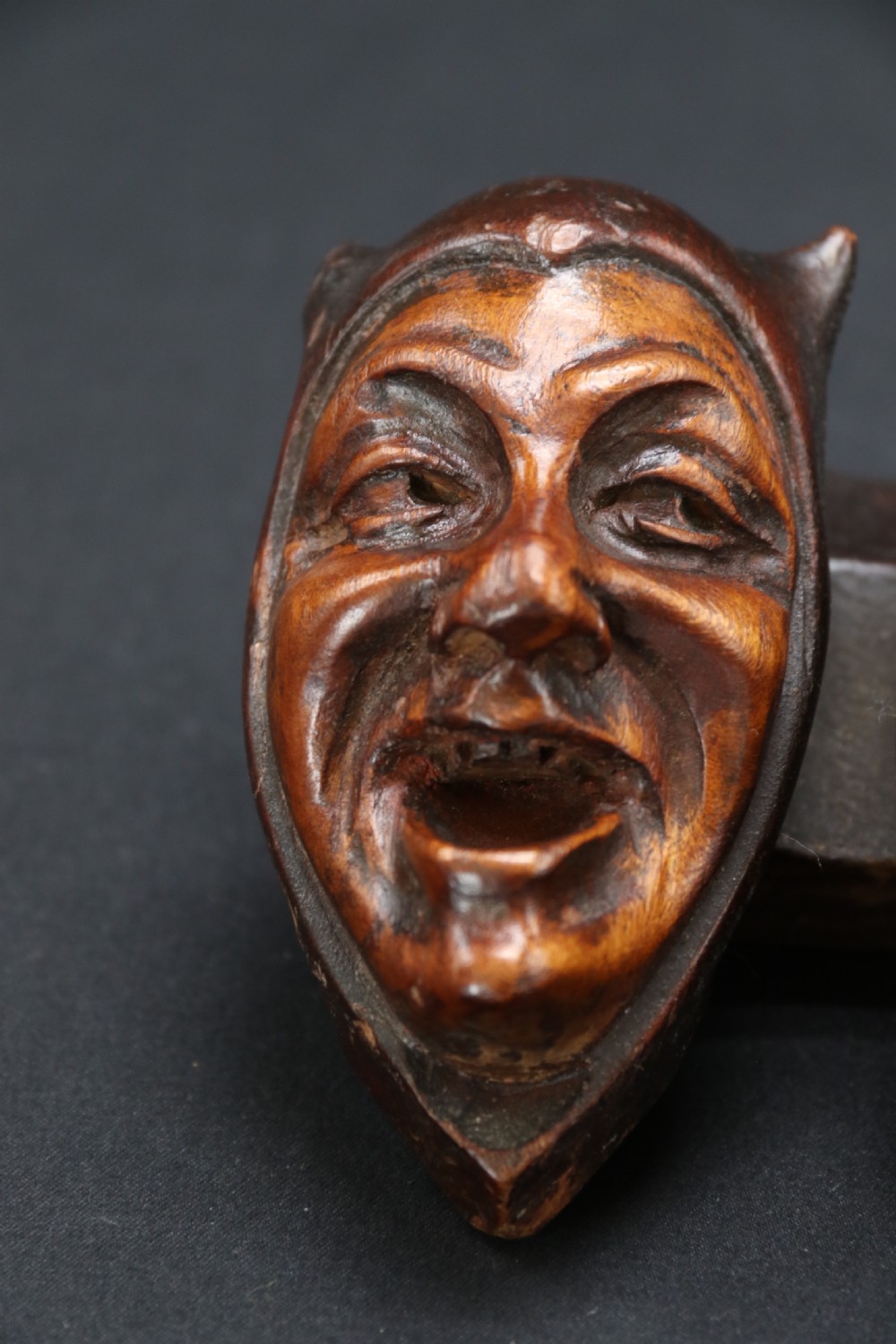 A superb Black Forest spoon rack carved in the devilish faces of the seven deadly sins. View V