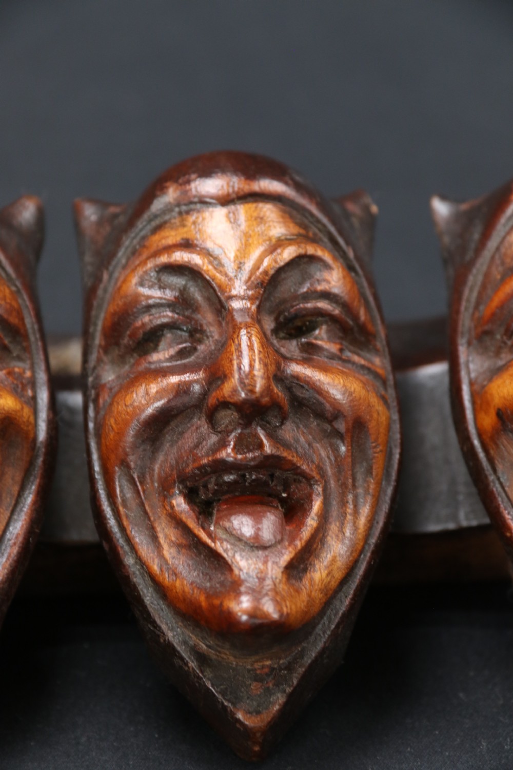 A superb Black Forest spoon rack carved in the devilish faces of the seven deadly sins. View VIII